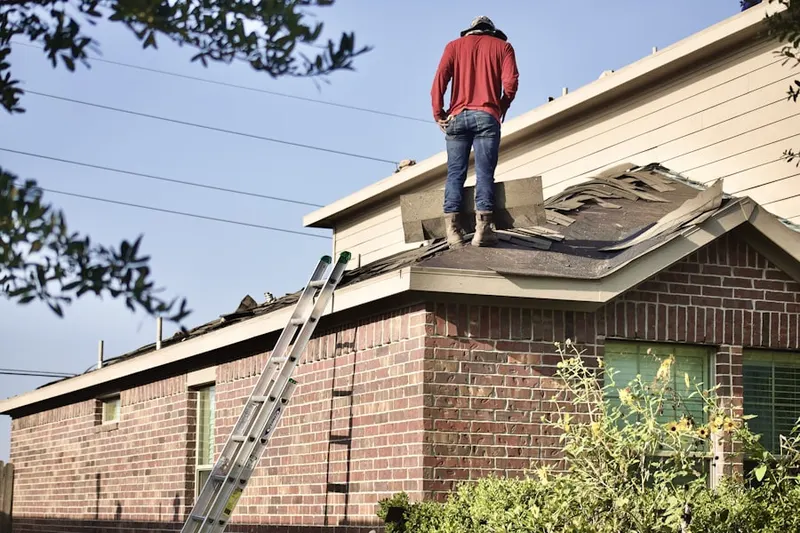 Professional roofer working on a residential roof in Keyes